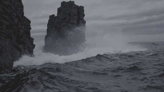 Waves crashing against rocky cliffs