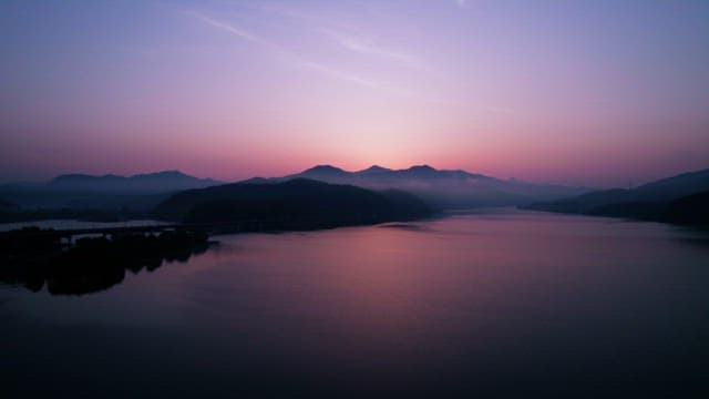 Serene Sunrise Over Misty Mountains