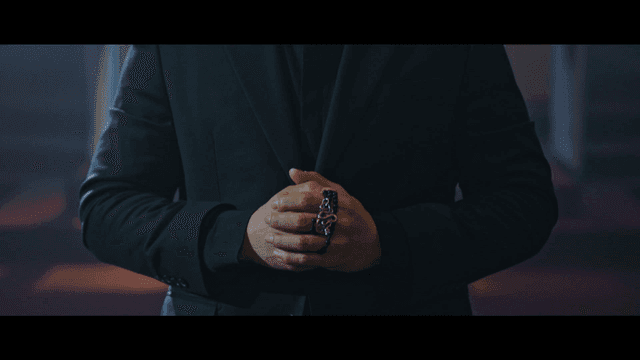 Priest wearing black suit and holding his hands together