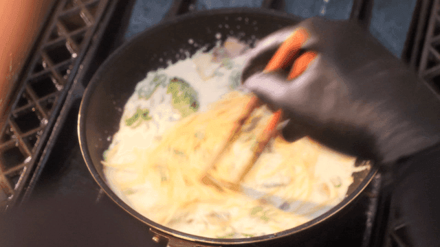 Cooking creamy pasta with vegetables