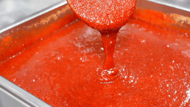 Red gochujang sauce poured onto tray