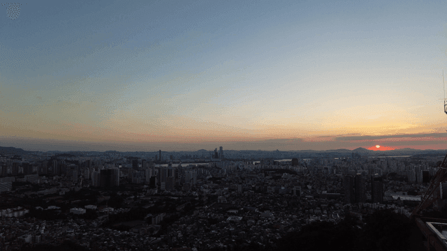 Sunset over a sprawling city skyline