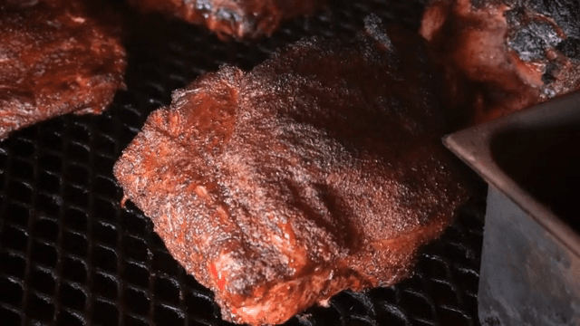 Grilled meat cooking on a barbecue grill