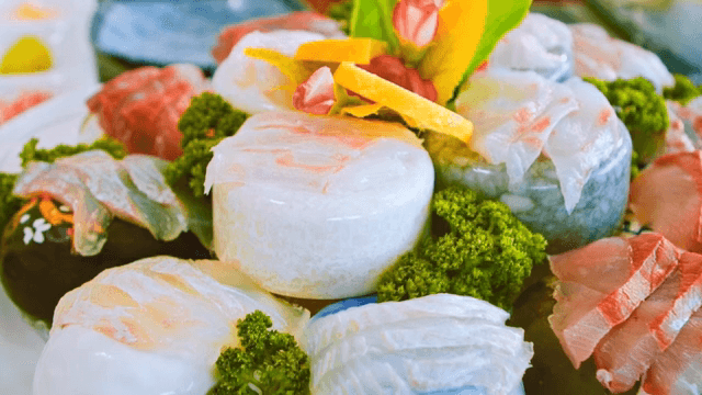Fresh sashimi slices on a decorative plate