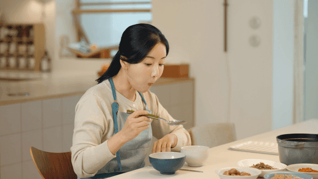 Middle-aged woman eating white rice at home