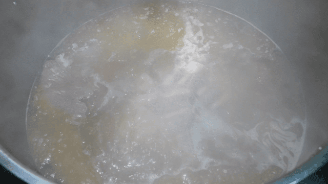 Beef rib soup broth boiling on stove