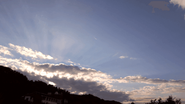 Sunlight streaming through clouds in the sky