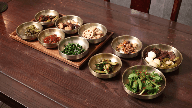 Various Korean side dishes on table