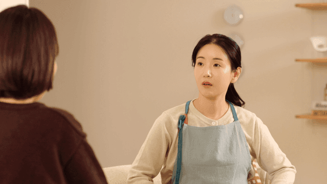 Mother and daughter talking while folding laundry