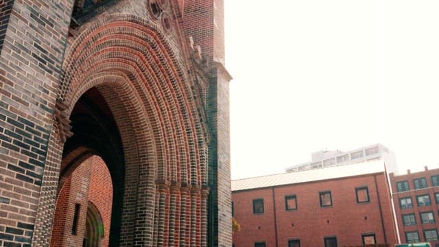 Elaborate brick entrance of a historic cathedral under bright sunlight