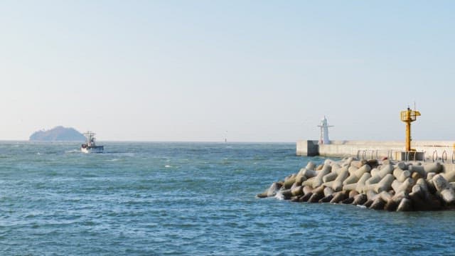 Secluded sea with isolated islands and small fishing boats