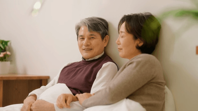 Elderly couple relaxing together indoors