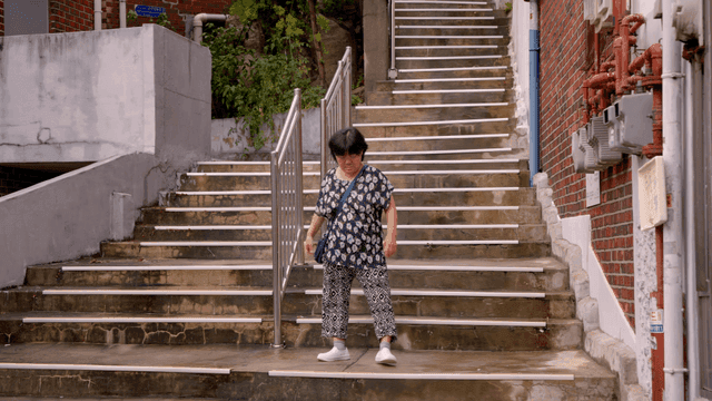 A woman walking down outdoor stairs