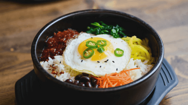 Bowl of bibimbap topped with various garnishes