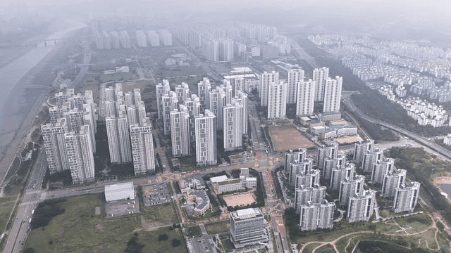 Aerial view of city landscape featuring modern high-rise apartments