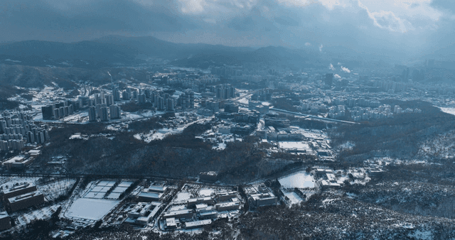Snow-covered cityscape with mountains