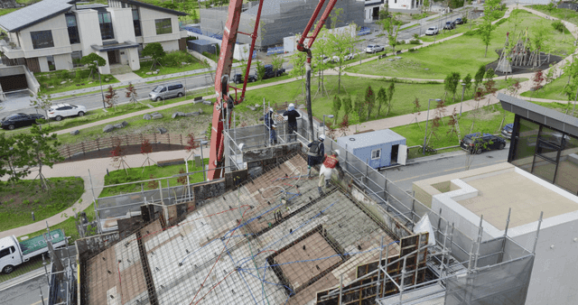 Construction workers pouring concrete
