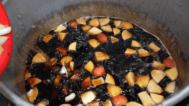 Scene of putting fruit pieces into pot full of soy sauce