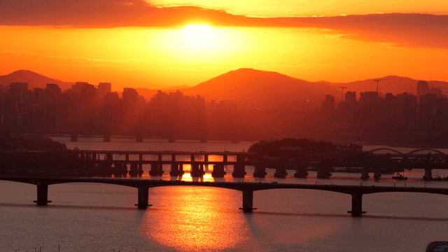 Sunset over a city skyline with bridges