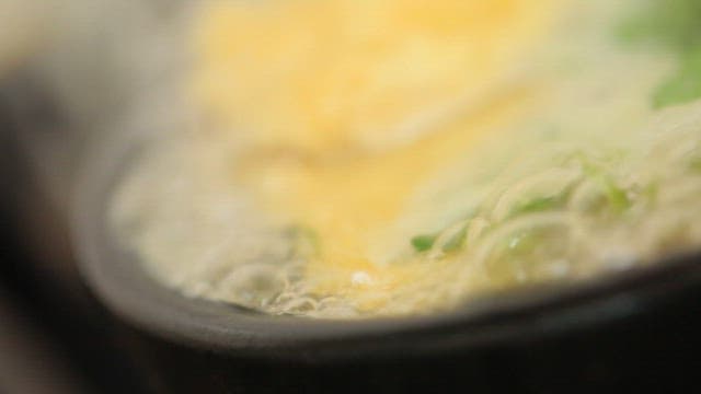 Soup with bubbling broth in a pot