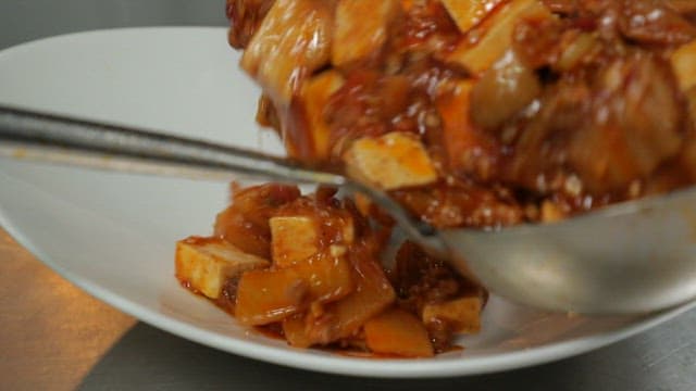 Mapo tofu plated on a white plate