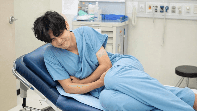Male patient suffering in bed
