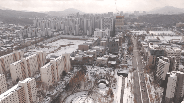 Snow-covered cityscape with high-rise buildings