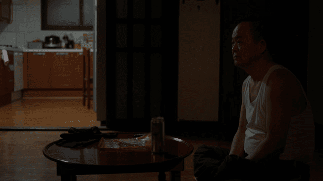 Man sitting in dark living room