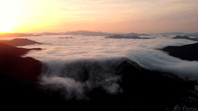 Mountains covered in clouds at sunrise