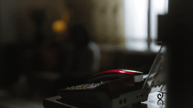 Red telephone in dark house