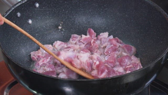 Frying Meat on a Frying Pan with Oil