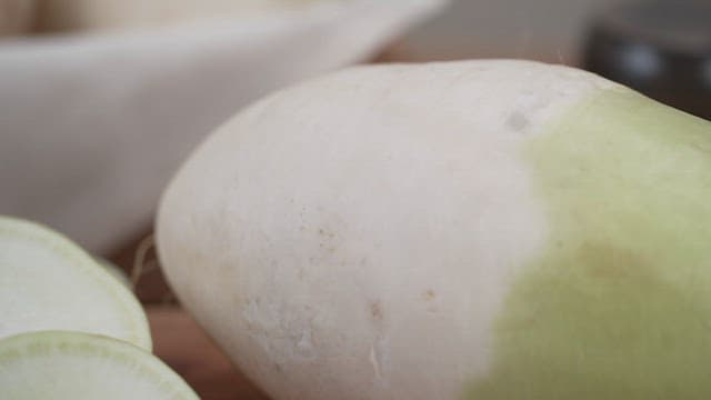 Surface of fresh green radish on a kitchen counter