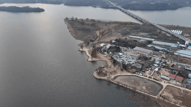 Riverside scenery with bridge and village
