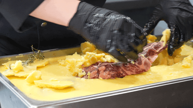 Chef preparing butter-aged steak