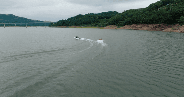 People water skiing on a large lake