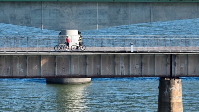 Cyclists riding on a bridge over a river