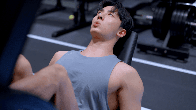 Man doing leg press exercise at gym with focus