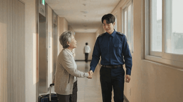 Police officer greeting elderly person in apartment hallway