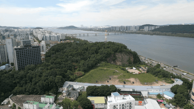 Cityscape with river and green hills