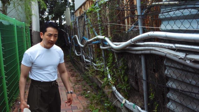 Man preparing to fight in an alley