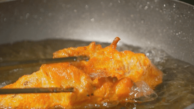 Golden fried fish in hot oil