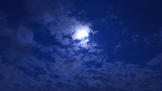 Night Sky with Moon Peeking Through Clouds