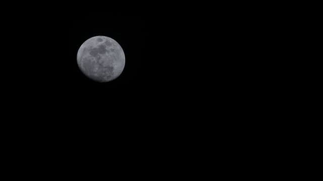 Full moon in a cloudy night sky