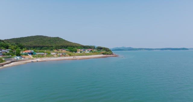 Coastal landscape with distant mountains