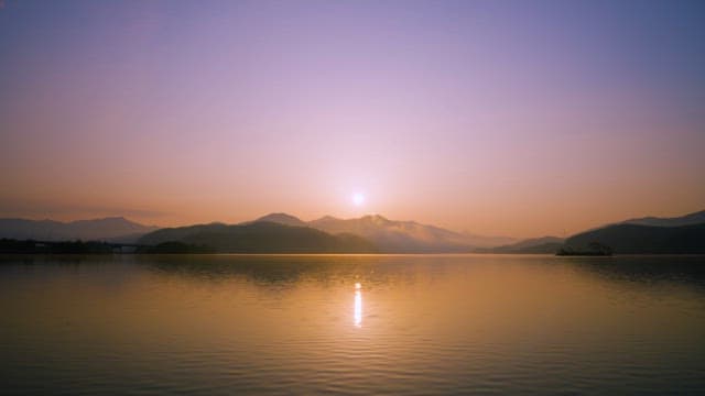 Serene Lakeside Sunrise with Mountains