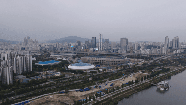 Sprawling cityscape with a large stadium