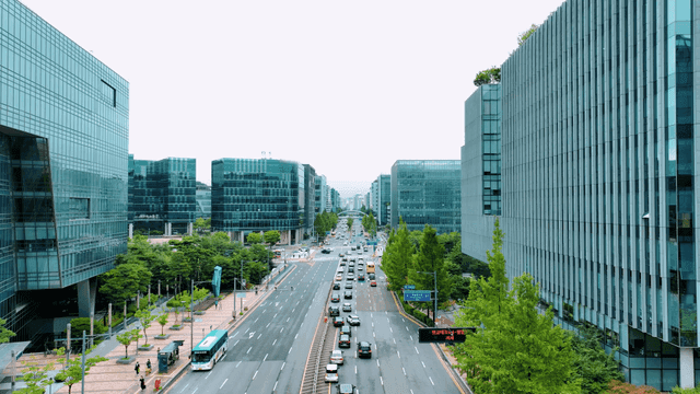 Bustling city street with modern buildings.