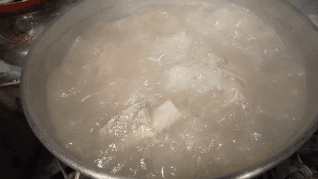 Pot of broth with boiling ribs