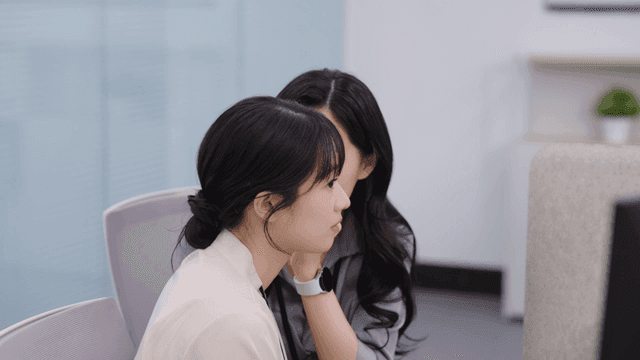 Two women working and discussing in an office