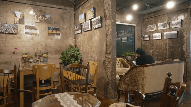 Cozy cafe interior with a man using a phone